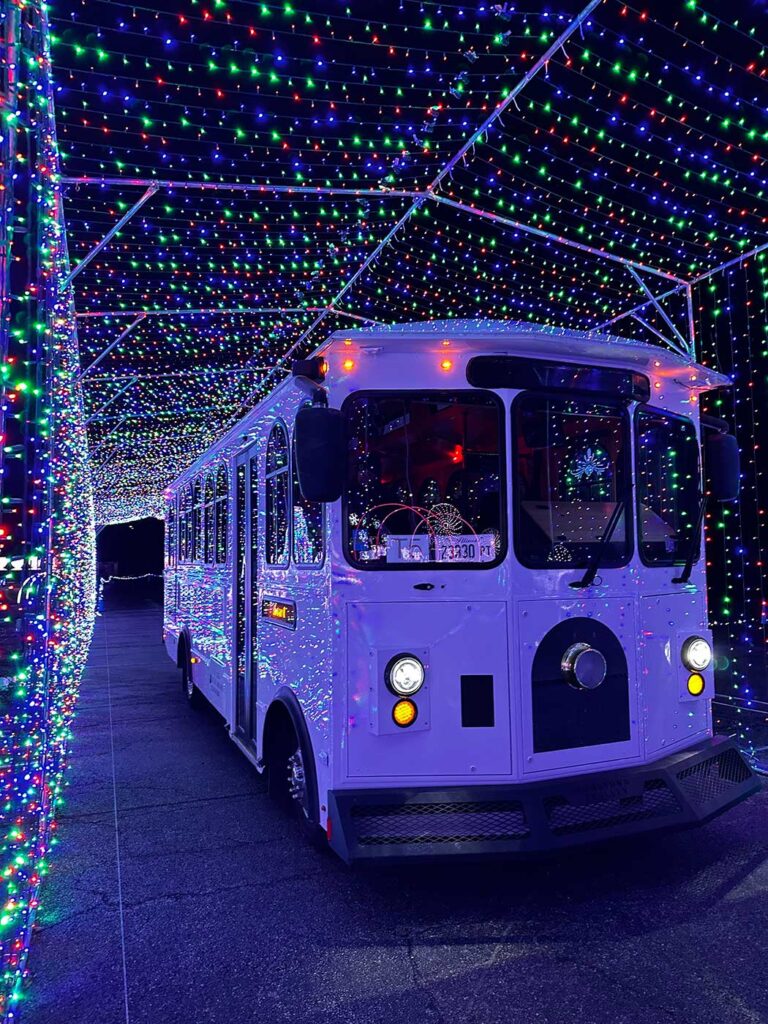 View of the front of the Jolly Trolley going through the tunnel of blue lights.