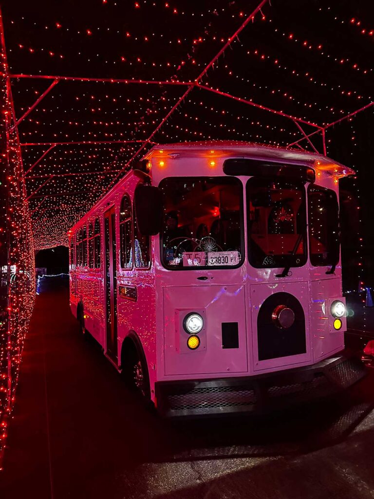 View of the front of the Jolly Trolley going through the tunnel of red lights.