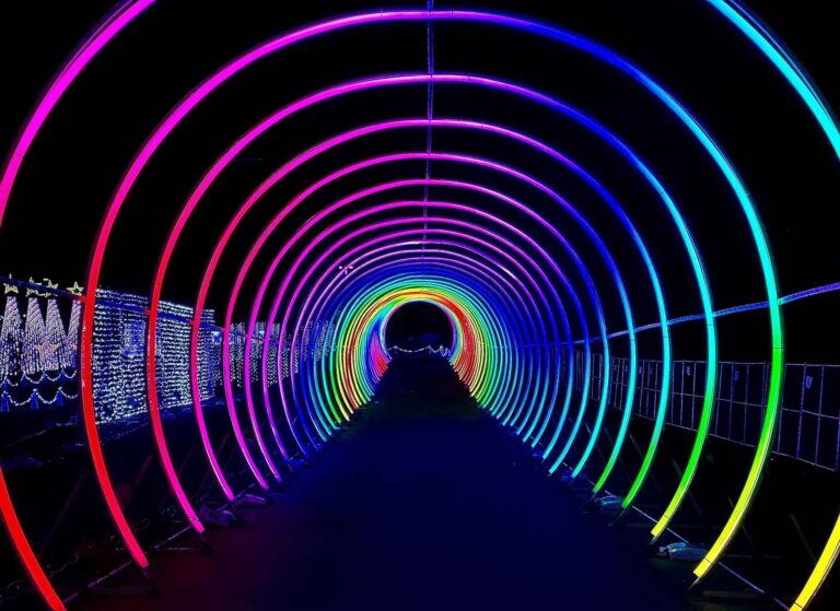 Tunnel of rainbow colored neon lights.